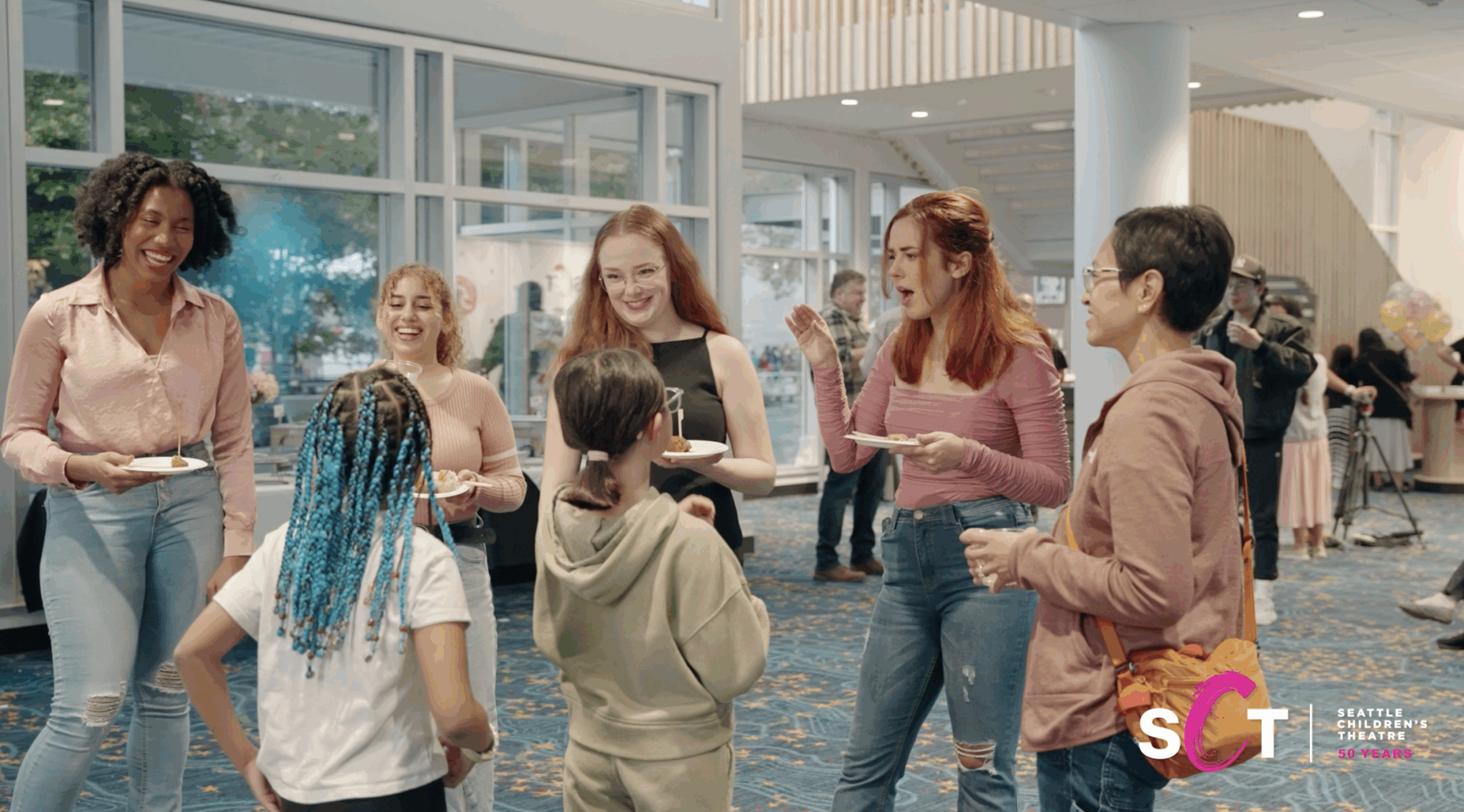 Group of parents and students in the lobby of The Seattle Children's Theatre